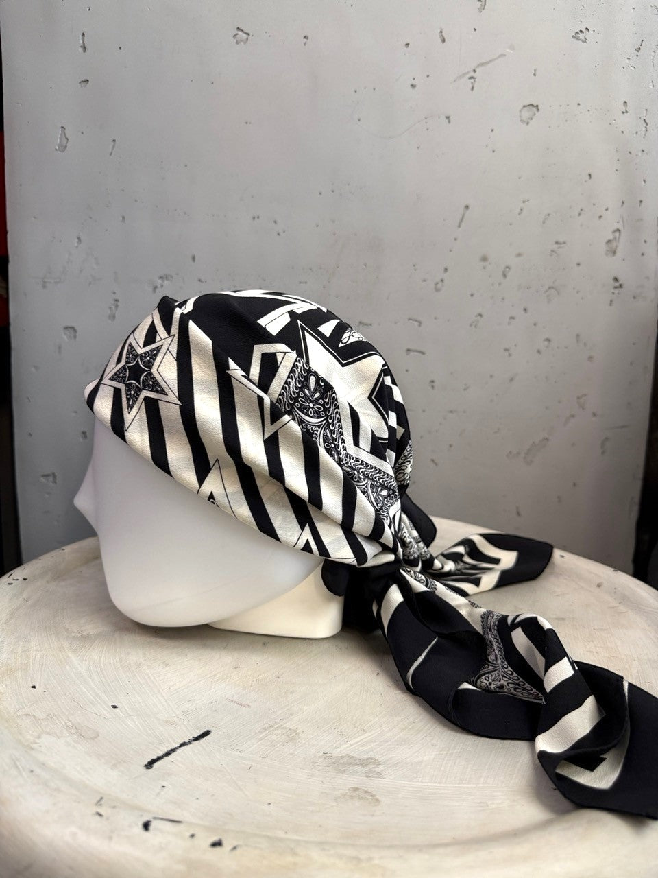 BERLIN VINTAGE CORNER Escada silk scarf in black and white with star and stripe print styled on a mannequin head