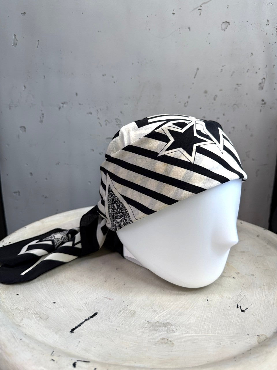 BERLIN VINTAGE CORNER Escada silk scarf in black and white with star and stripe patterns on a mannequin head