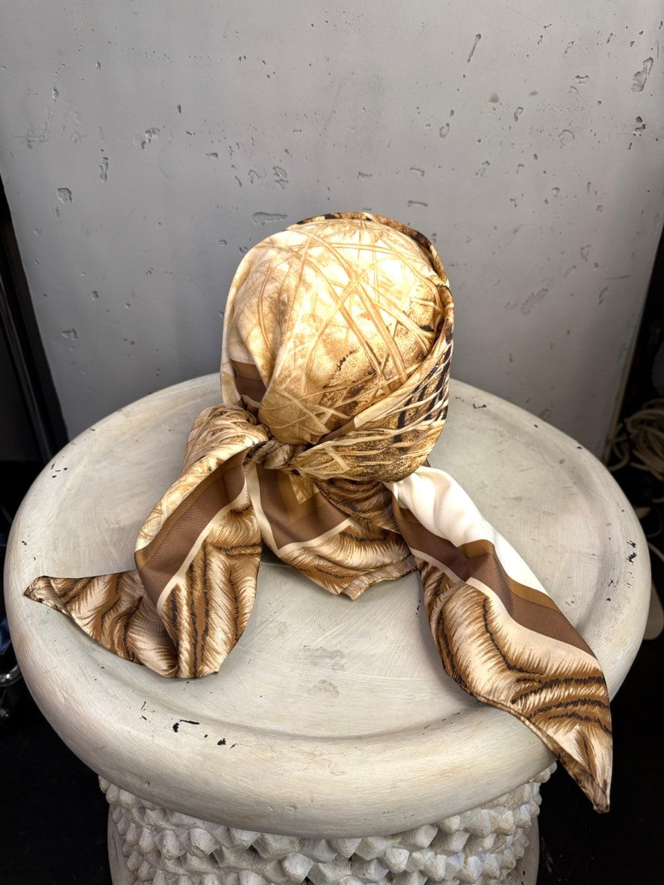 BERLIN VINTAGE CORNER Escada silk scarf featuring a tiger motif in cream, tan, and brown, styled as a headpiece.
