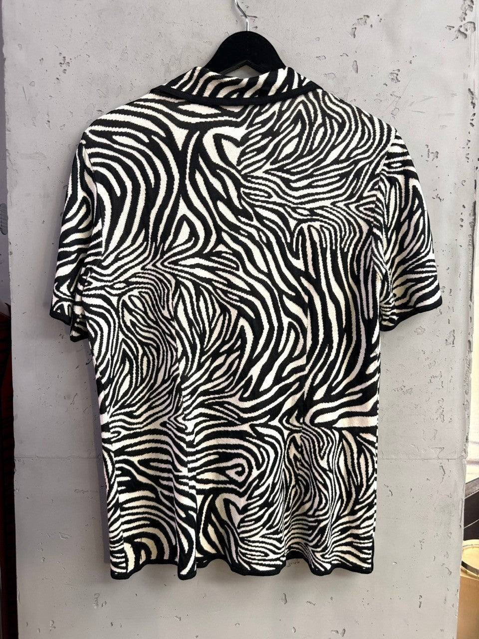 BERLIN VINTAGE CORNER Escada vintage short-sleeve knit shirt in black and white zebra print with a structured collar.