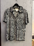BERLIN VINTAGE CORNER Escada vintage short-sleeve knit shirt featuring a black and white zebra print pattern.