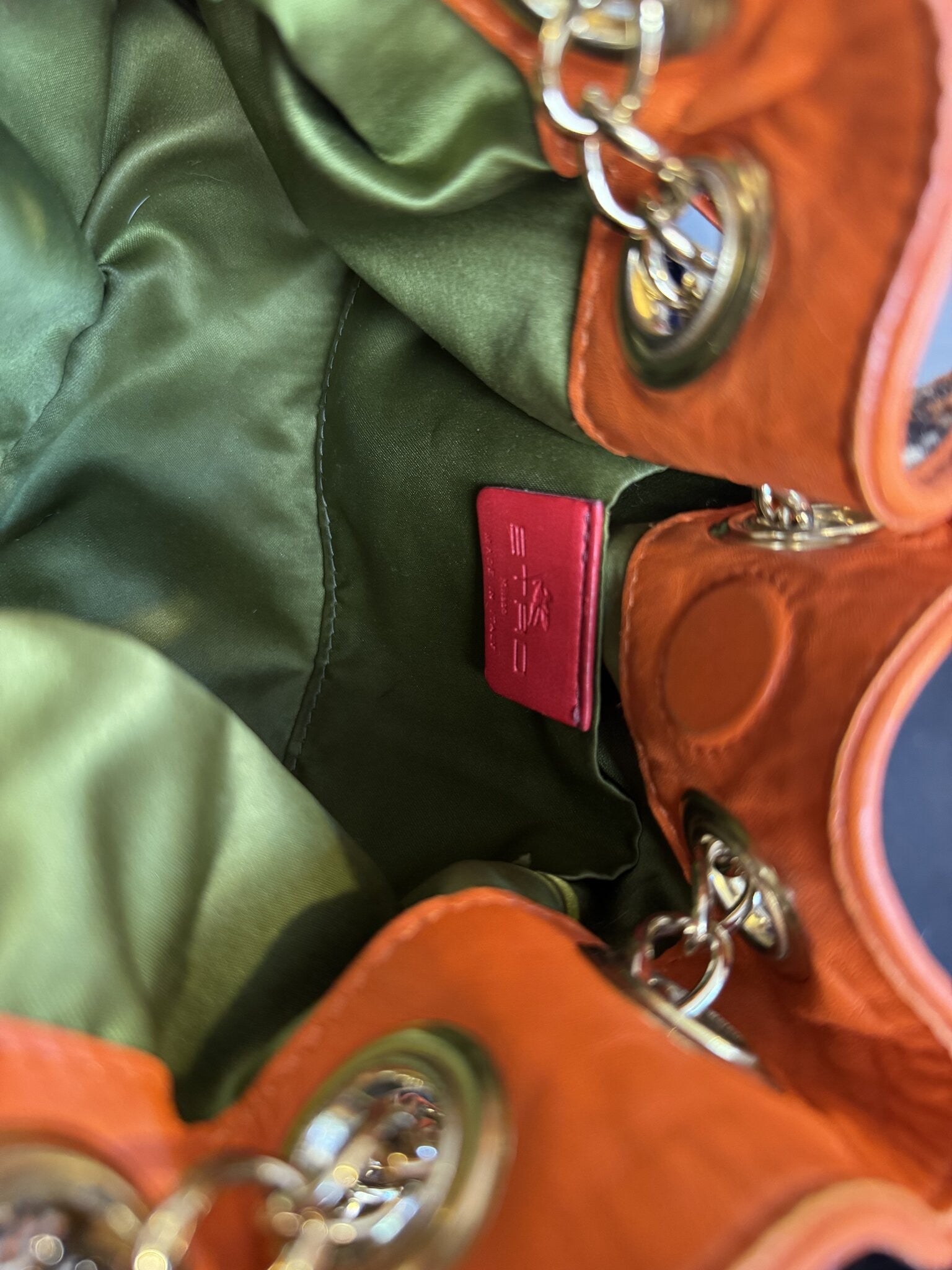 BERLIN VINTAGE CORNER ETRO bucket bag interior with olive green lining, orange leather trim, and embossed logo tag