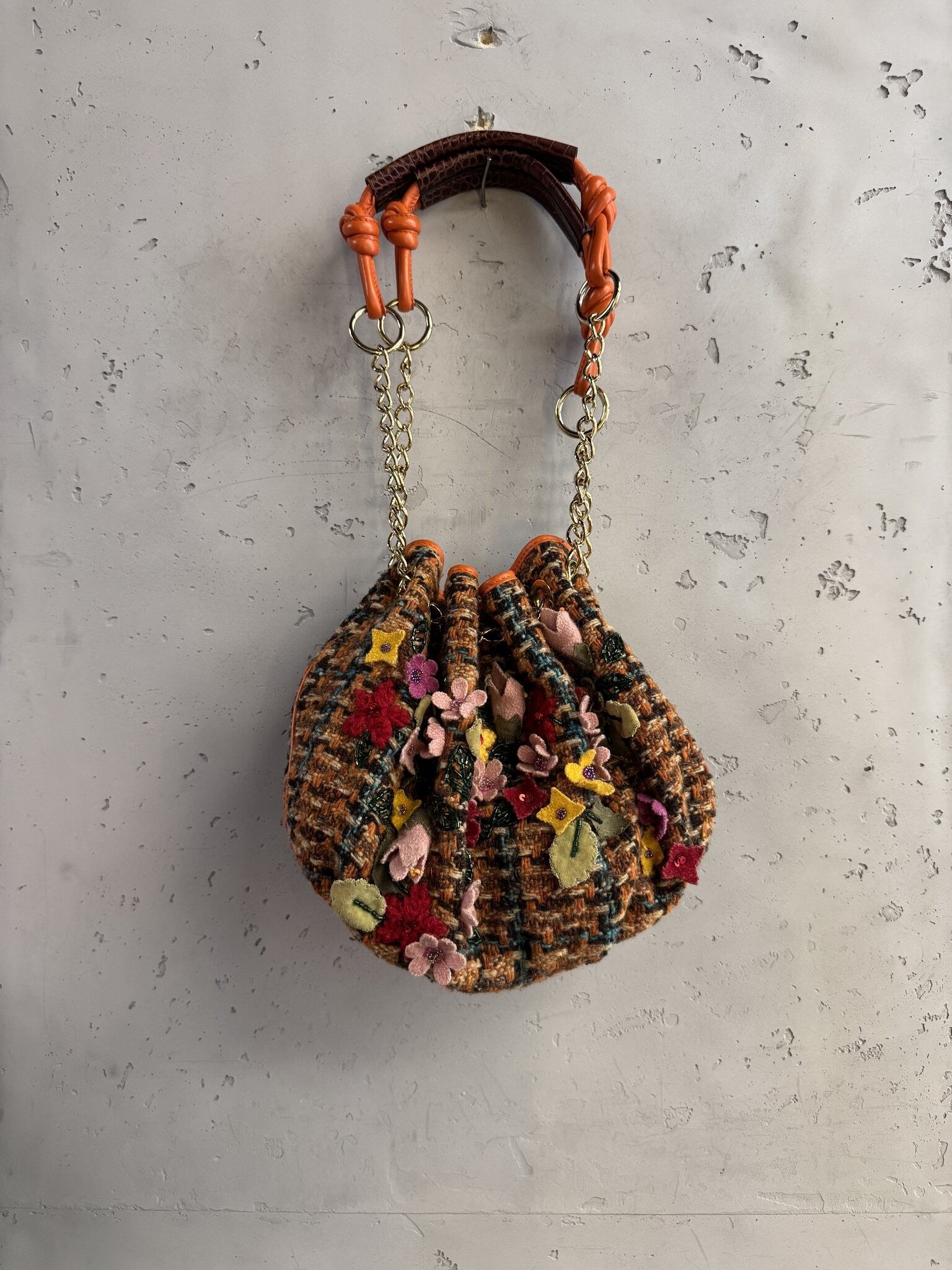 BERLIN VINTAGE CORNER ETRO tweed bucket bag with felt floral appliqués, orange leather trim, and gold chain strap.