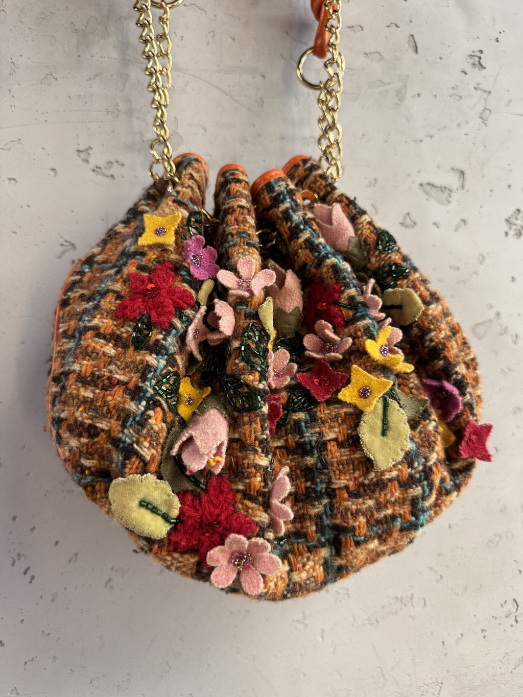 BERLIN VINTAGE CORNER ETRO tweed bucket bag with felt floral appliqués, beadwork, and orange leather trim details.