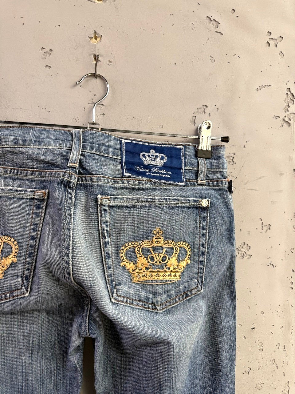 BERLIN VINTAGE CORNER mid-wash denim jeans with gold crown embroidery on back pockets and blue logo patch.