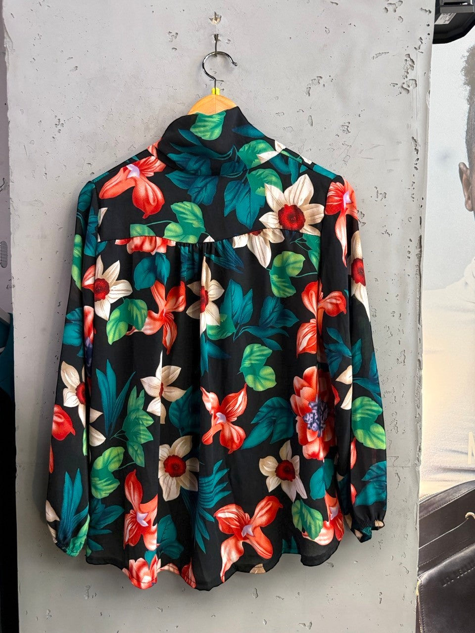 BERLIN VINTAGE CORNER long sleeve blouse in black with a vibrant multi-colored floral print and high-neck tie detail.
