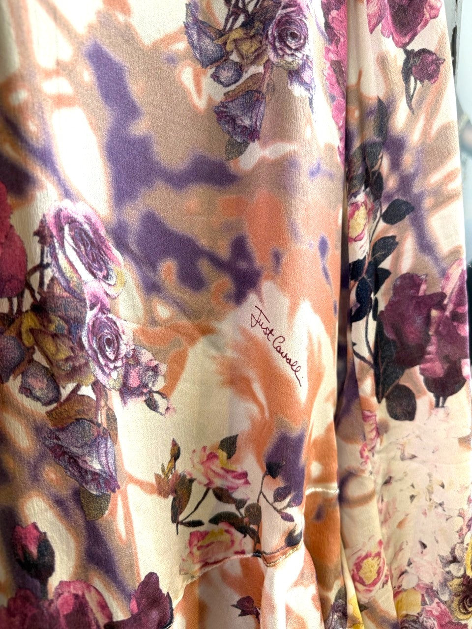 BERLIN VINTAGE CORNER floral print long sleeve blouse with ruffled neckline and tie cuffs in purple, pink, orange, and ivory.