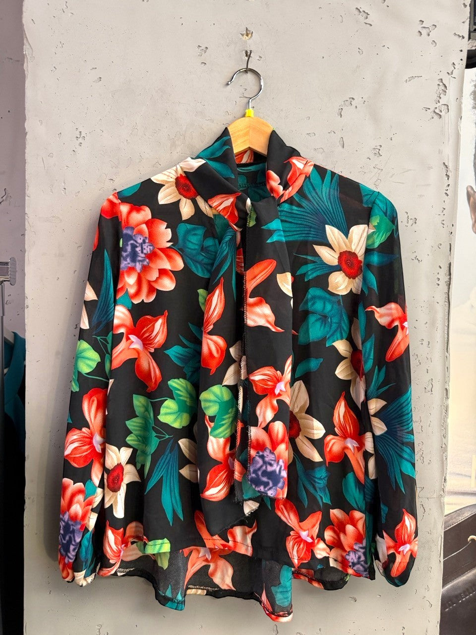 BERLIN VINTAGE CORNER long sleeve blouse with vibrant floral print on black fabric and high-neck tie detail.