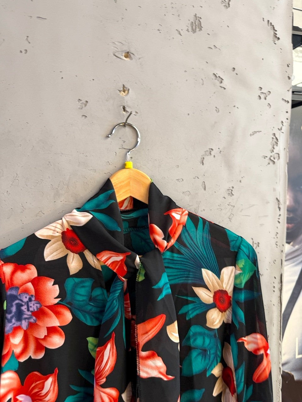 BERLIN VINTAGE CORNER long sleeve blouse with vibrant tropical floral print on black fabric and high-neck tie detail.