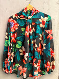 BERLIN VINTAGE CORNER floral print long sleeve blouse with high-neck tie detail and black background.