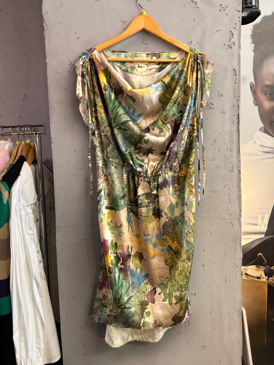 BERLIN VINTAGE CORNER floral print drape neck midi dress with green, blue, purple, and yellow botanical print. Lightweight fabric with tie shoulder details.