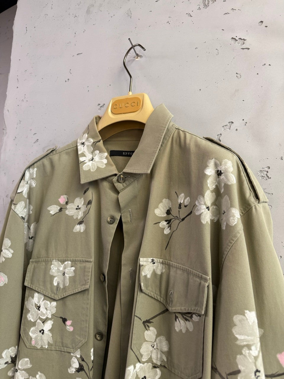 BERLIN VINTAGE CORNER olive green military style overshirt with hand-painted white and pink cherry blossoms on back and sleeves.