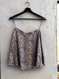 BERLIN VINTAGE CORNER black mini skirt with ditsy floral print in pink, blue, and white. A-line silhouette.