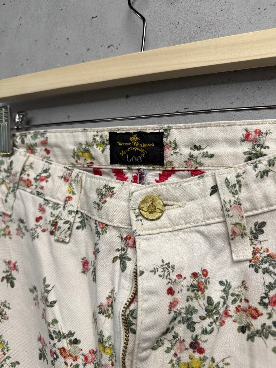 BERLIN VINTAGE CORNER white cotton twill trousers with all-over pink, yellow, and green floral print.