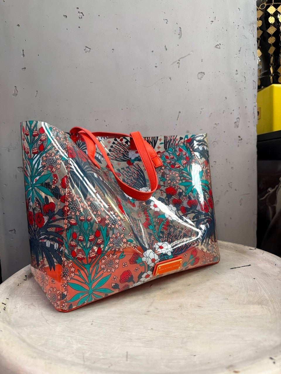 BERLIN VINTAGE CORNER Marc by Marc Jacobs transparent PVC tote with red, teal, and white floral print and orange trim.