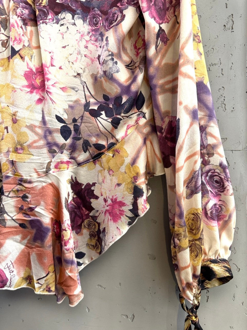 BERLIN VINTAGE CORNER floral print blouse with ruffled neckline, tie front, and leopard print cuffs in purple, pink, orange, and ivory.