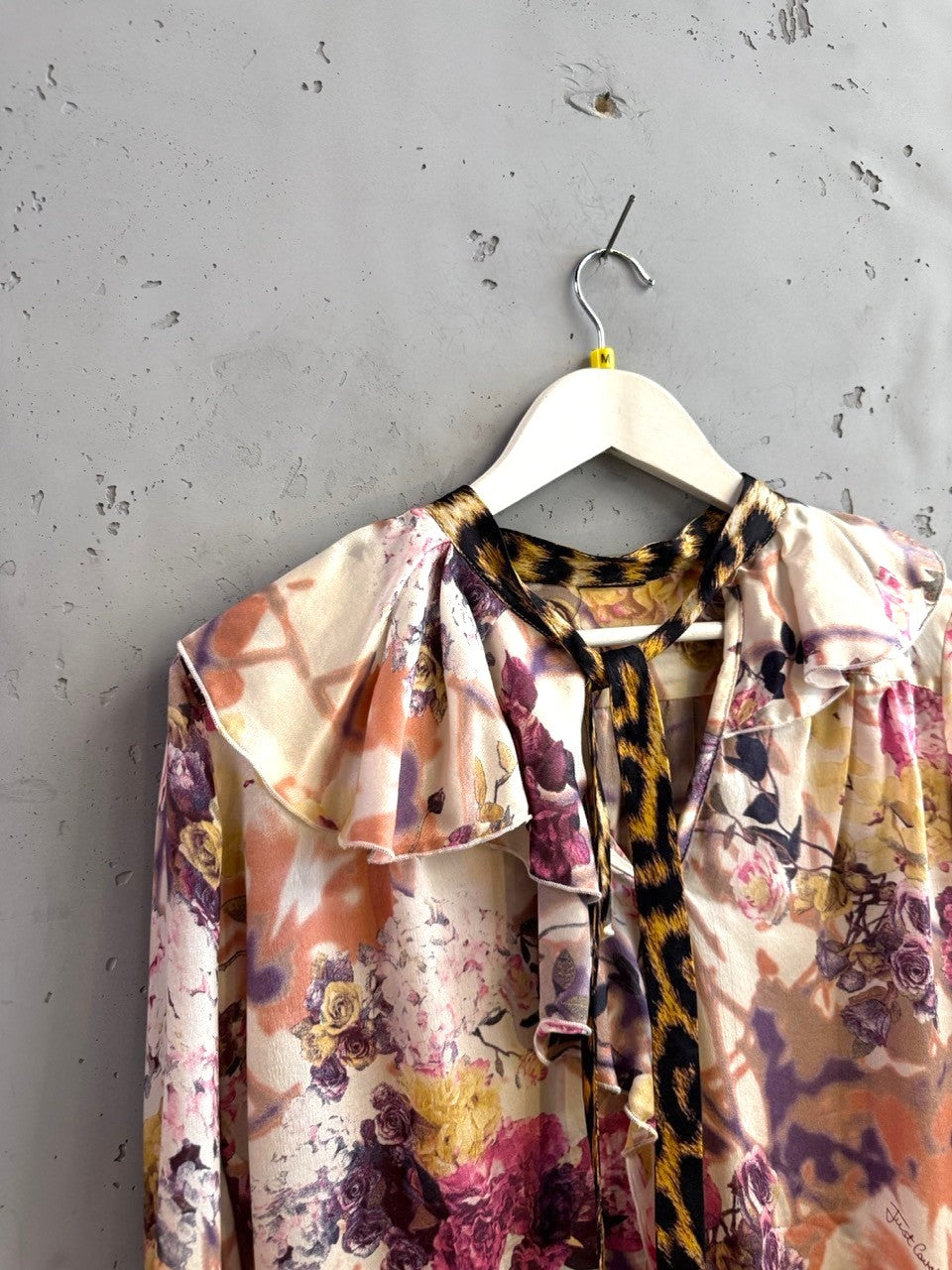 BERLIN VINTAGE CORNER floral print long sleeve blouse with ruffled neckline and leopard print accents. Creamy ivory with purple, pink, and orange flowers.