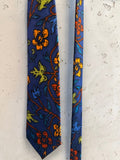 BERLIN VINTAGE CORNER navy blue tie with orange, yellow, and green floral pattern. Textured fabric.
