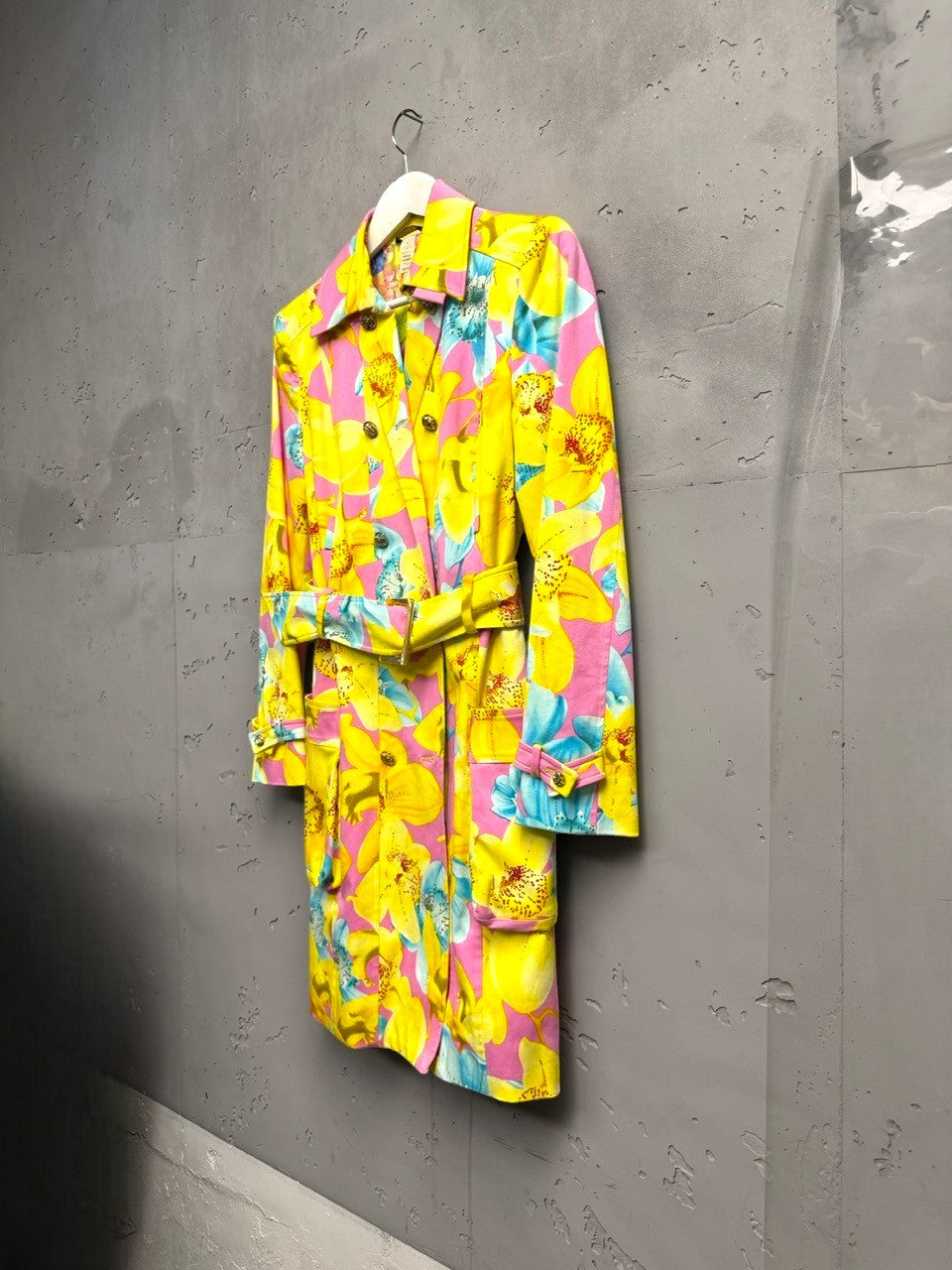 BERLIN VINTAGE CORNER yellow, pink, and blue floral print double-breasted trench coat with belt and gold buttons.