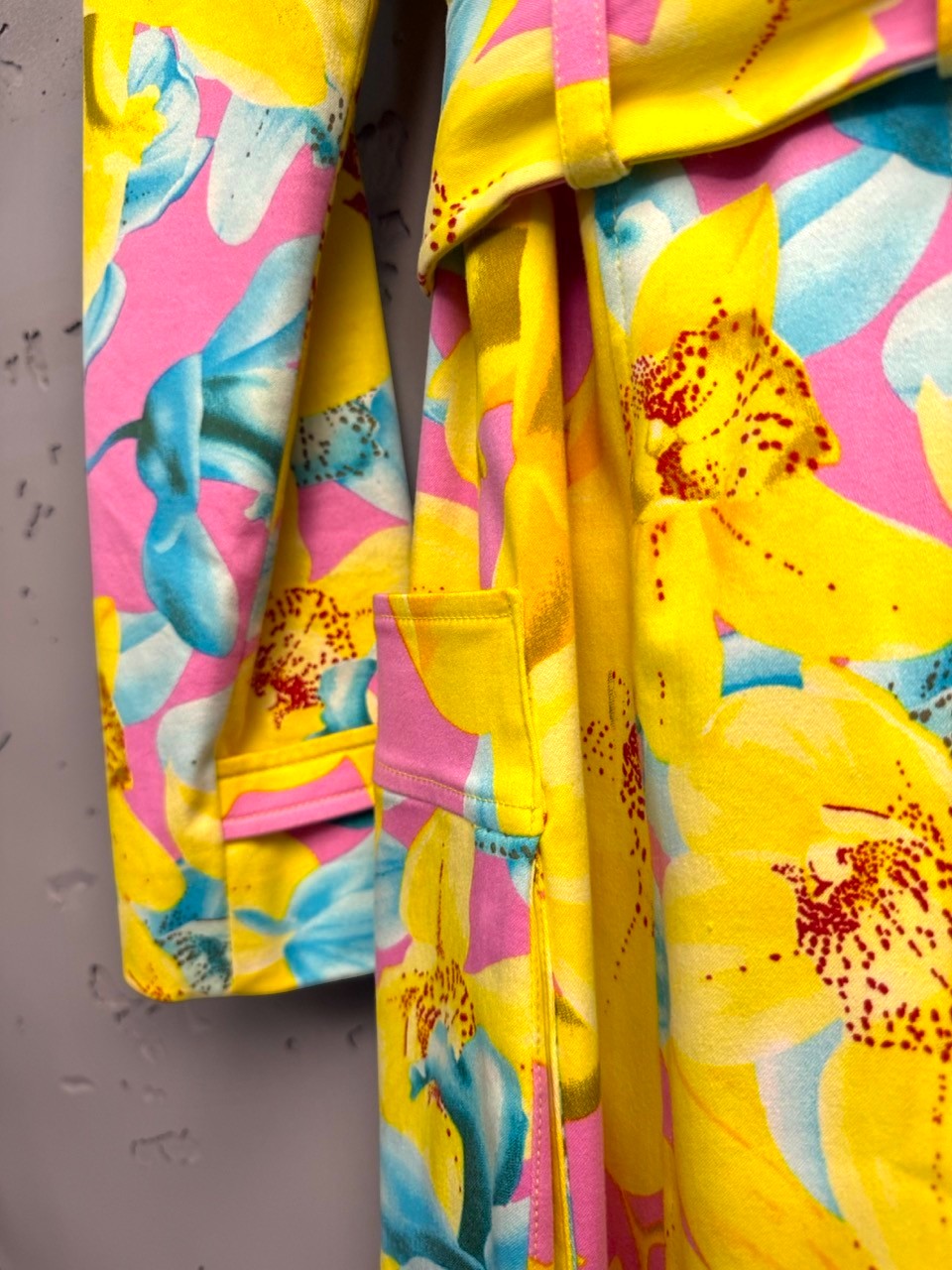 BERLIN VINTAGE CORNER yellow, pink, blue floral print double-breasted trench coat with belt and gold buttons.