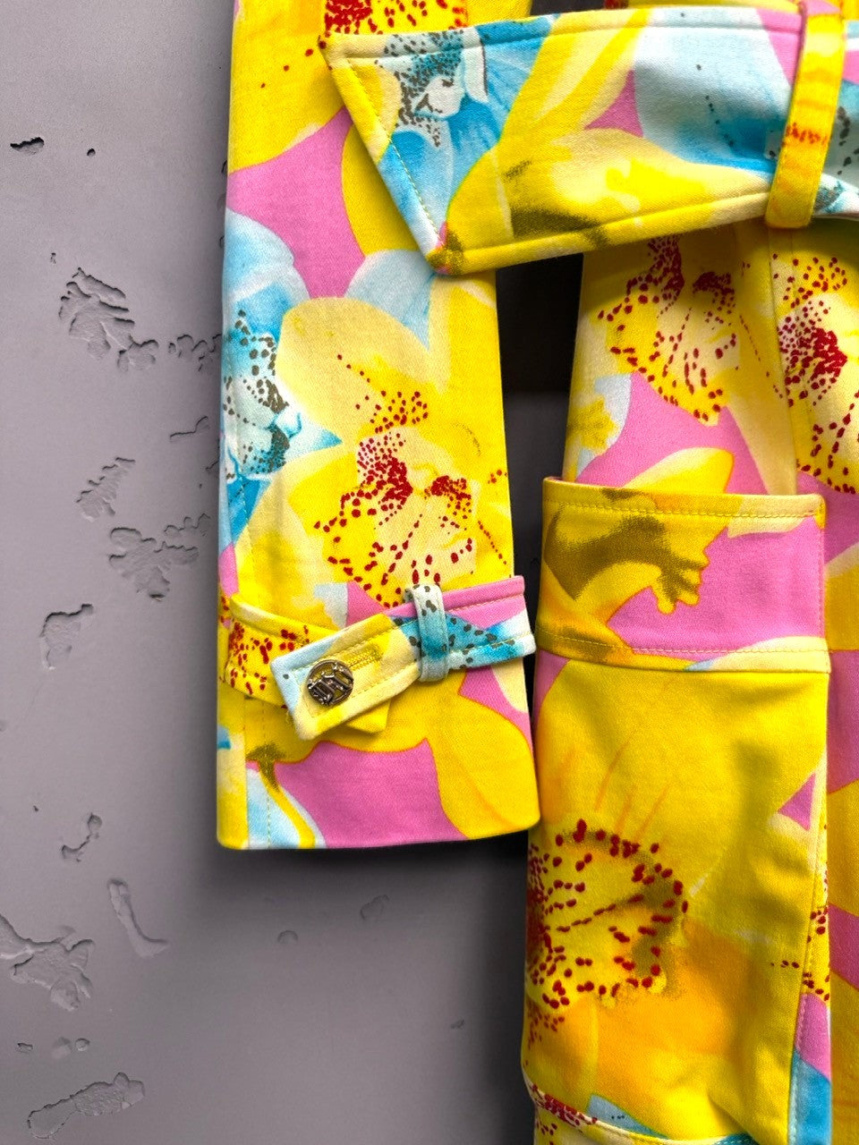 BERLIN VINTAGE CORNER yellow, pink, blue floral print double-breasted trench coat with belt and gold buttons.