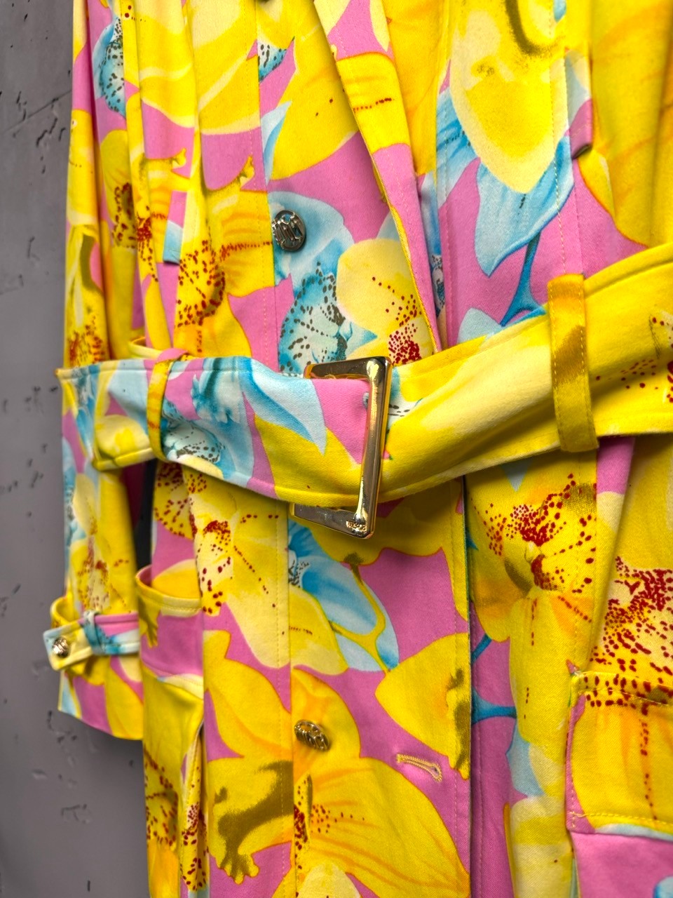 BERLIN VINTAGE CORNER yellow, pink, blue floral print double-breasted trench coat with gold buttons and belt.