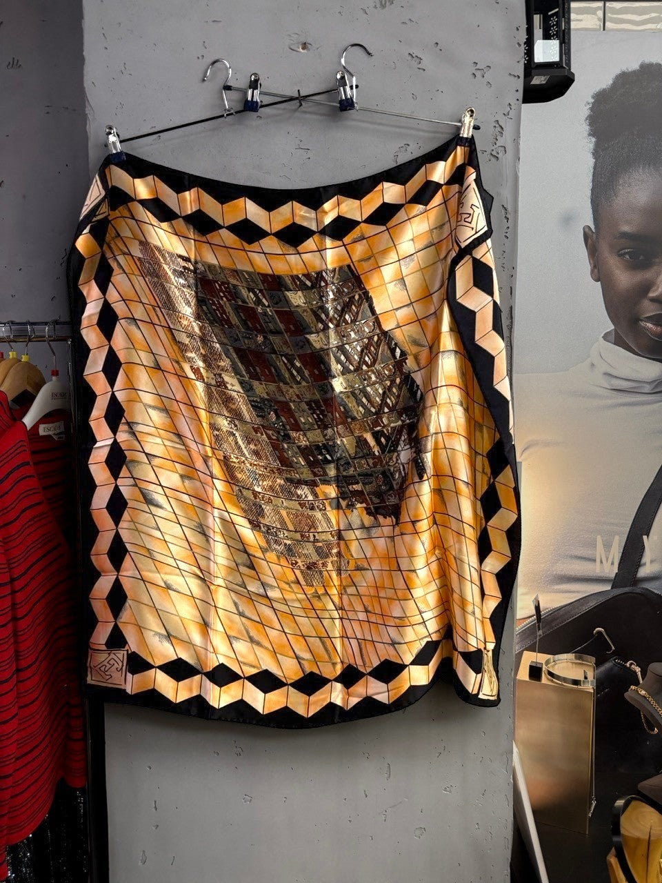 BERLIN VINTAGE CORNER silk scarf with a geometric grid pattern in peach, black, and earth tones with a bold border.