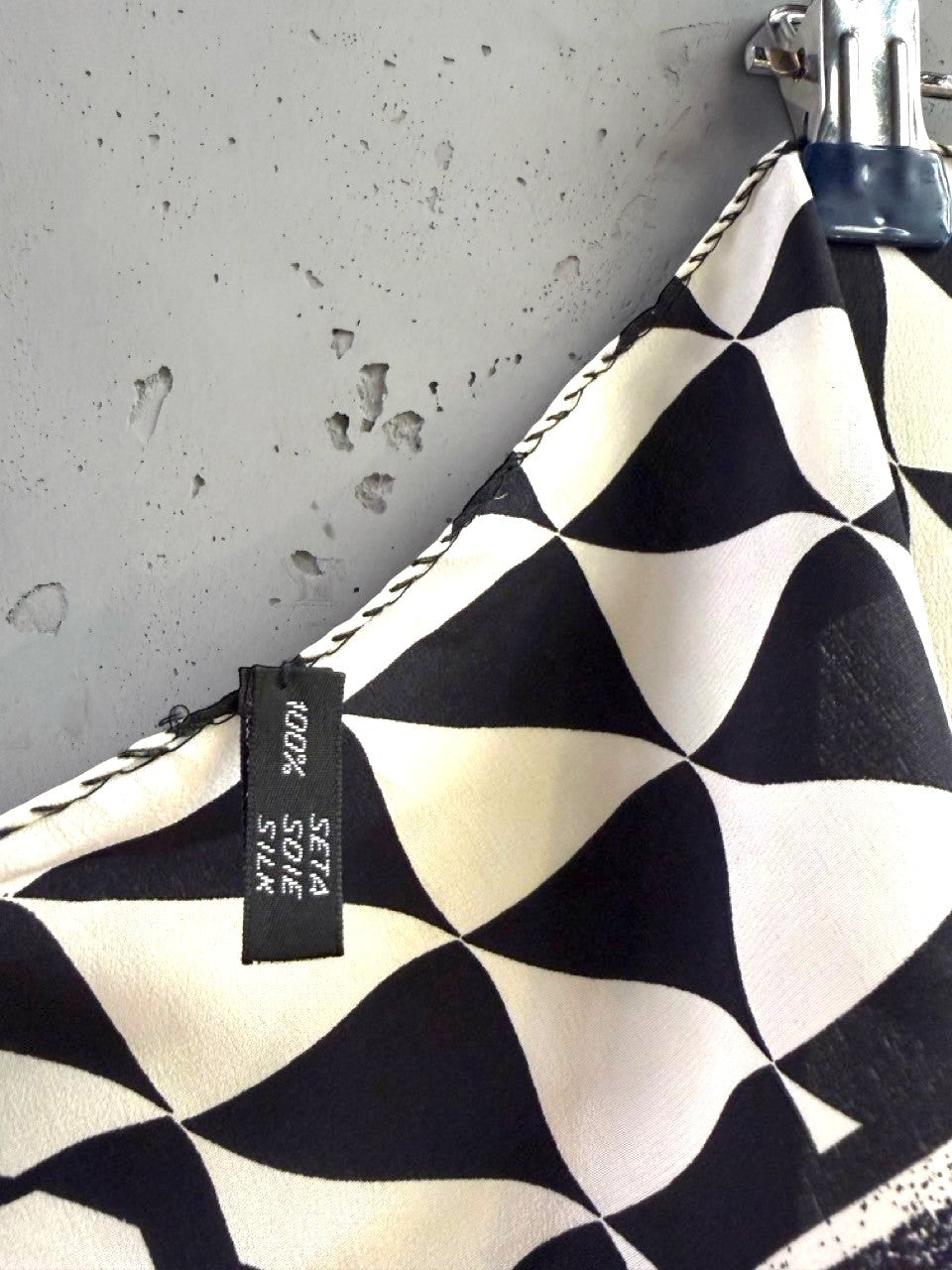 BERLIN VINTAGE CORNER black and white geometric silk scarf with a hand-rolled edge and 100% silk fabric tag.