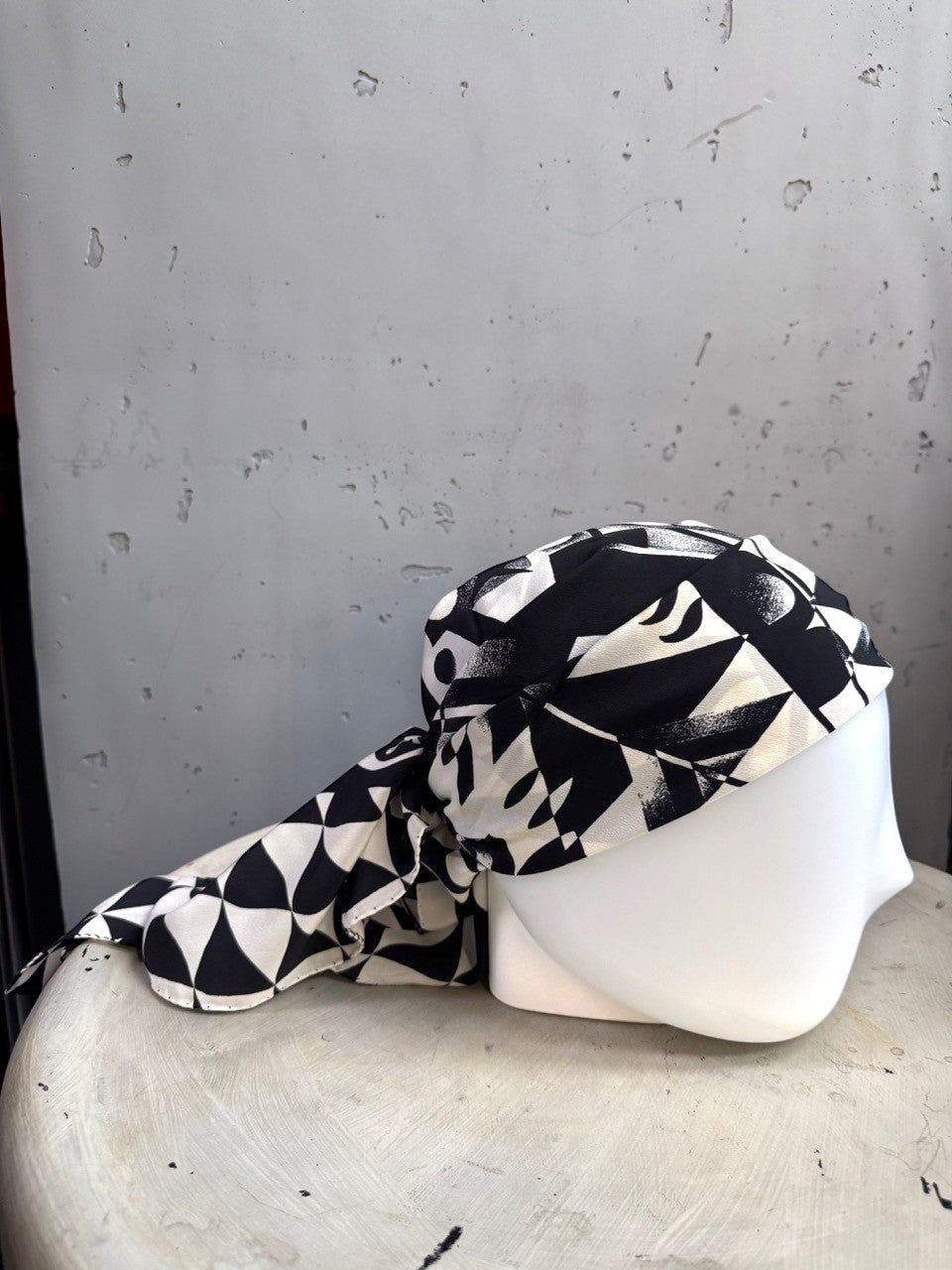 BERLIN VINTAGE CORNER black and white geometric silk scarf with abstract patterns draped on a mannequin head