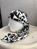 BERLIN VINTAGE CORNER black and white geometric silk scarf styled as a head wrap on a mannequin