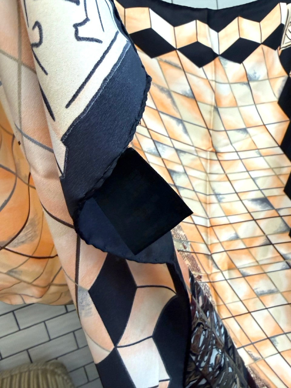 BERLIN VINTAGE CORNER silk scarf featuring a geometric peach and black grid pattern with a bold contrasting border.