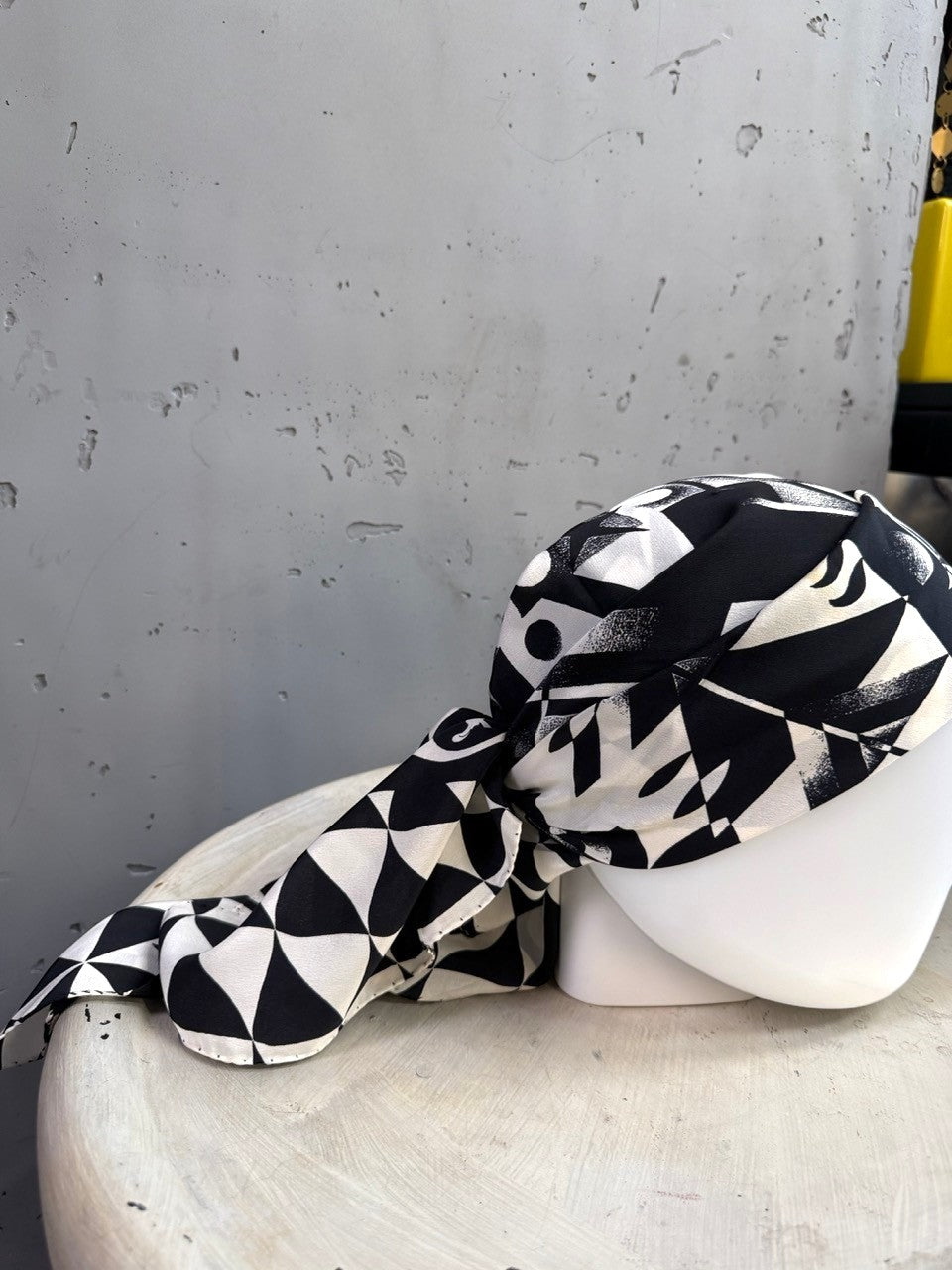BERLIN VINTAGE CORNER black and white geometric silk scarf styled as a head wrap on a mannequin