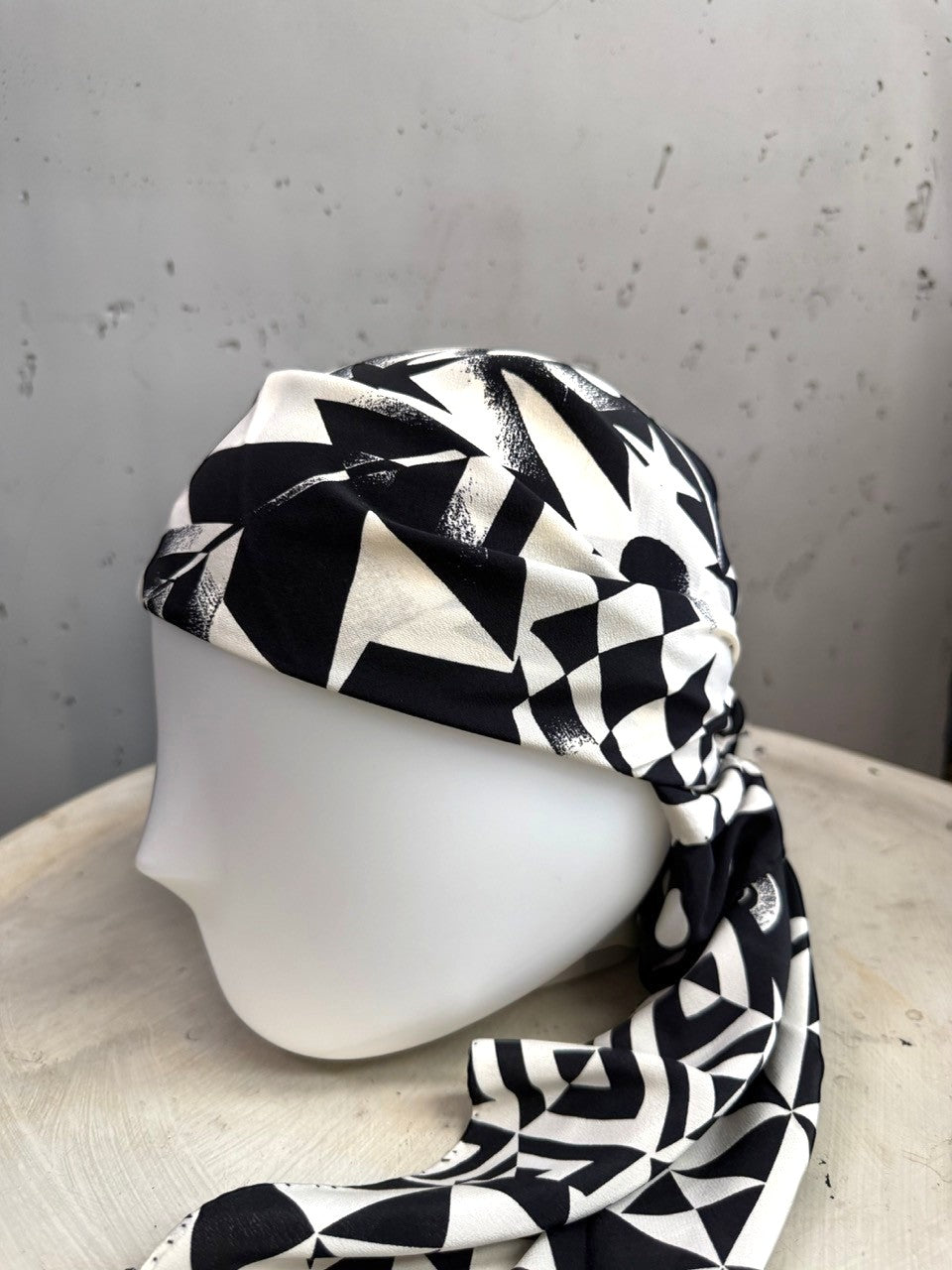 BERLIN VINTAGE CORNER black and white geometric silk scarf styled as a head wrap on a mannequin