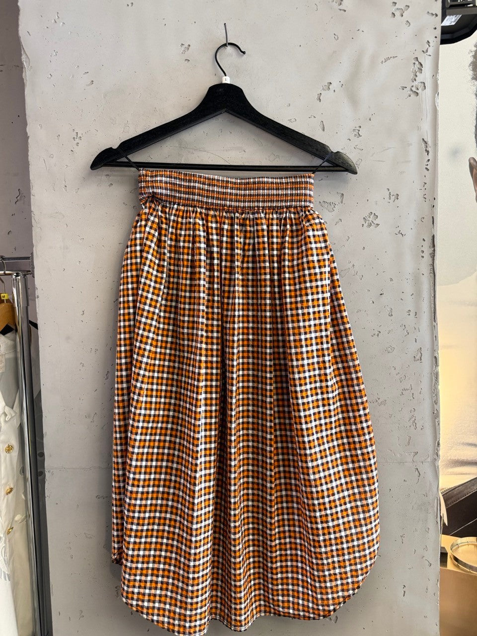 BERLIN VINTAGE CORNER orange, white, and black gingham check midi skirt with smocked waistband and A-line silhouette.