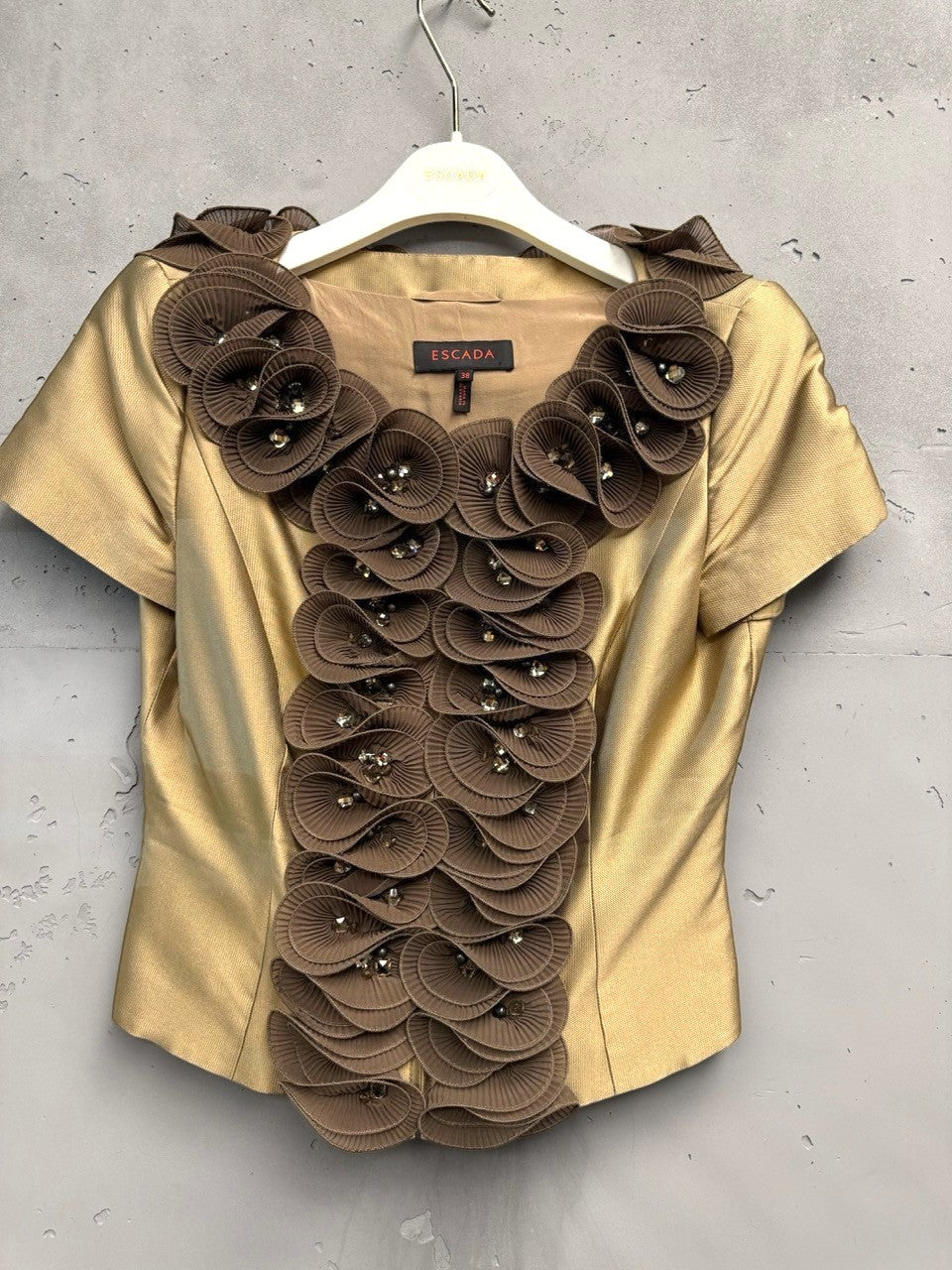 BERLIN VINTAGE CORNER gold-toned short-sleeved blouse with brown floral appliqué and crystal embellishments on the neckline and front.