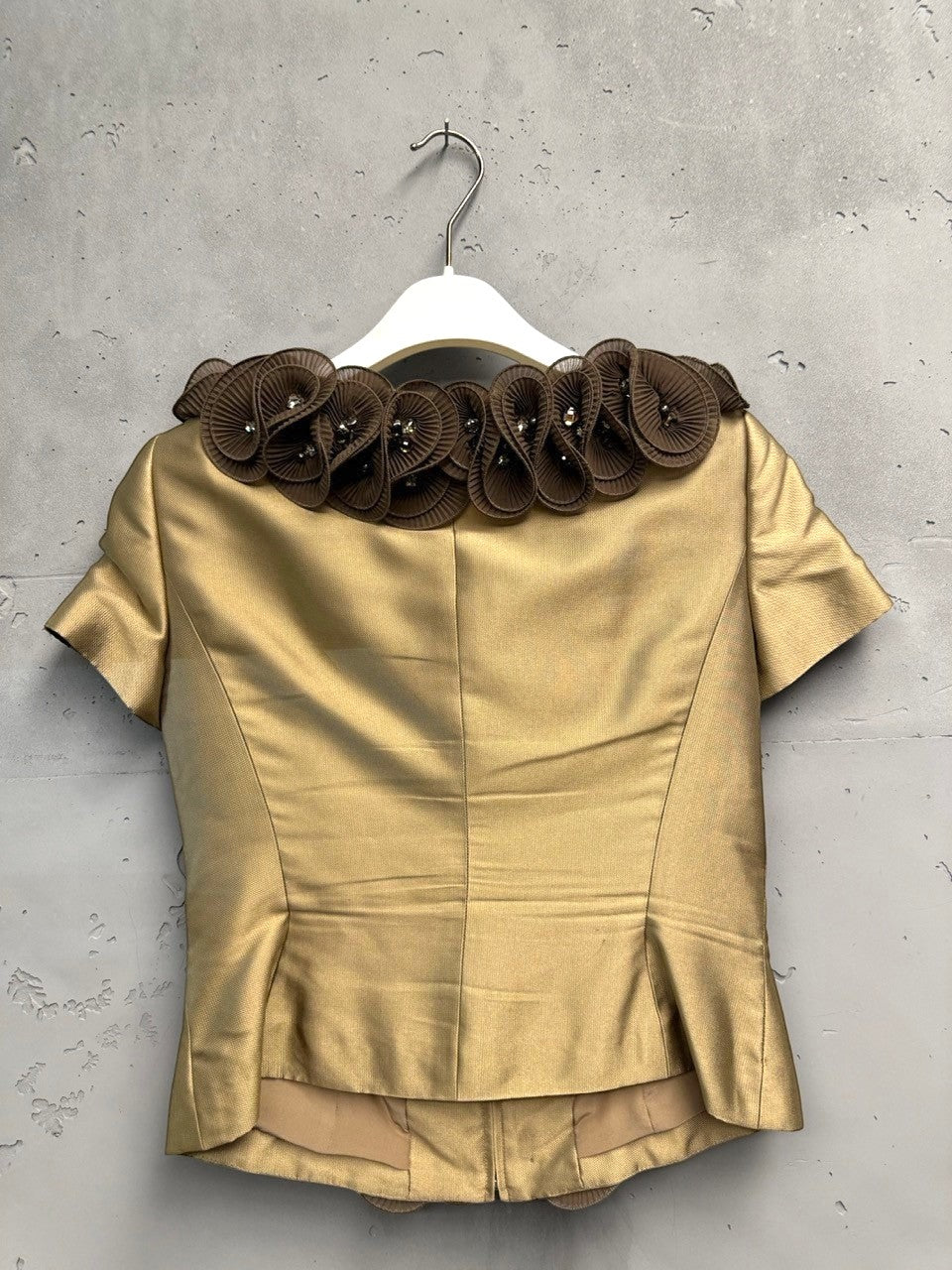 BERLIN VINTAGE CORNER gold-toned short-sleeved blouse with brown ruffled floral appliqué and crystal embellishments around the neckline.