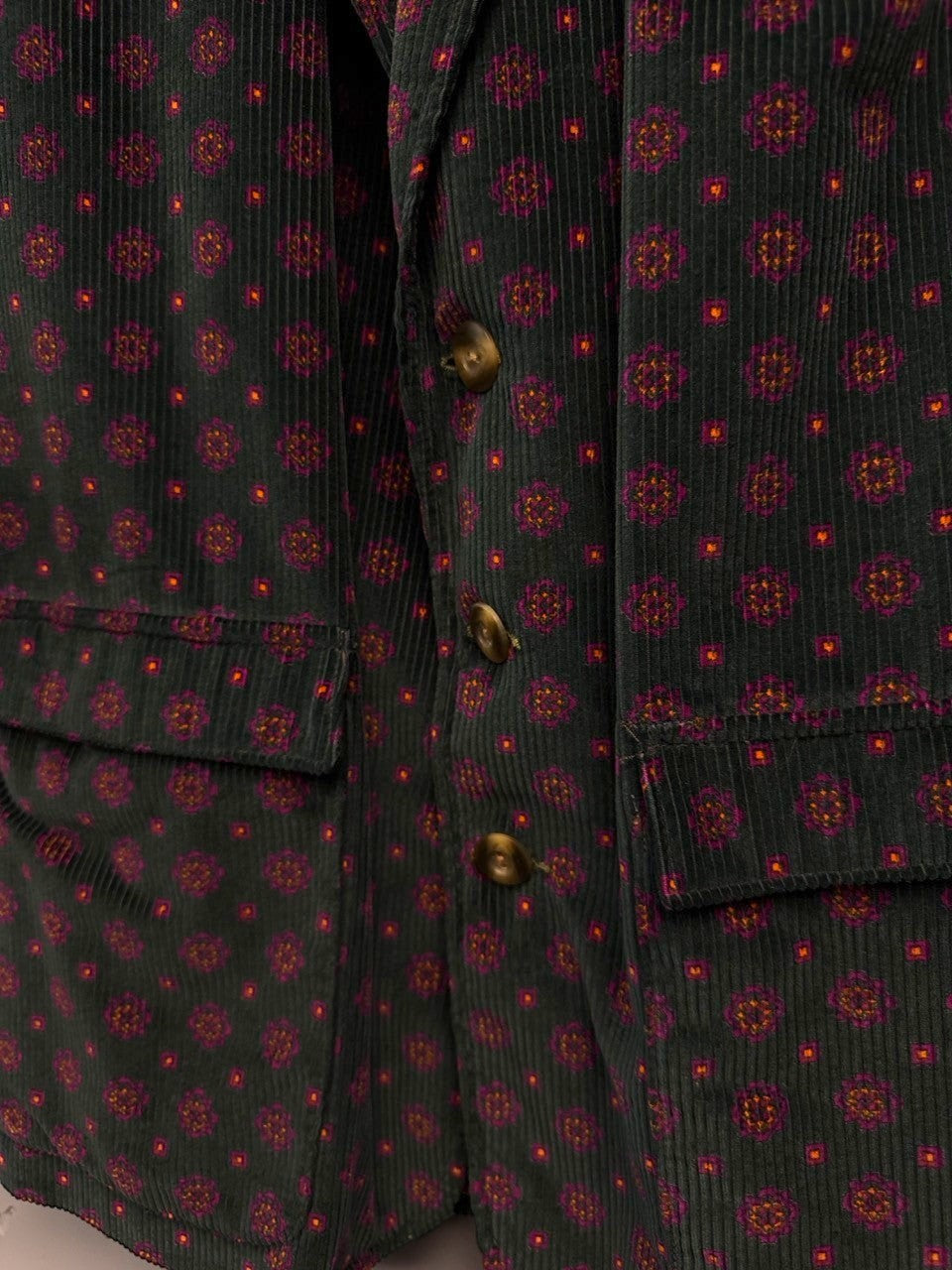 BERLIN VINTAGE CORNER dark green corduroy blazer with geometric print, two button closure, and flap pockets.