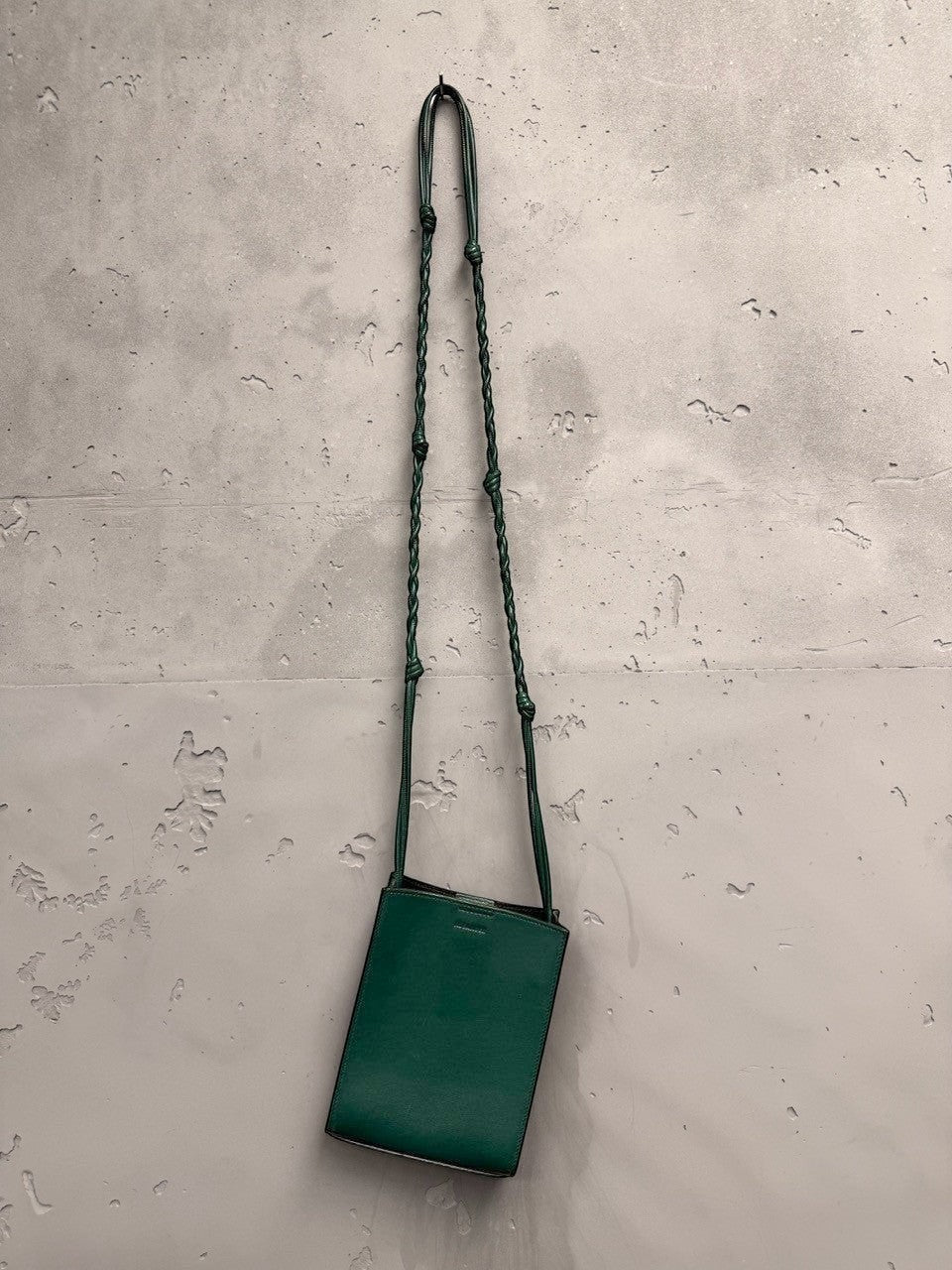 BERLIN VINTAGE CORNER forest green leather crossbody bag with braided adjustable strap and embossed logo.