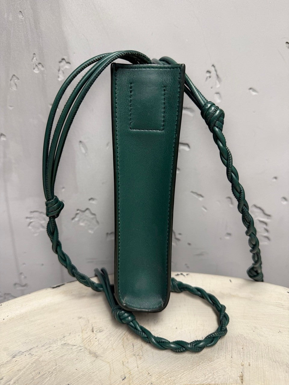 BERLIN VINTAGE CORNER forest green leather crossbody bag with braided strap and adjustable knots.