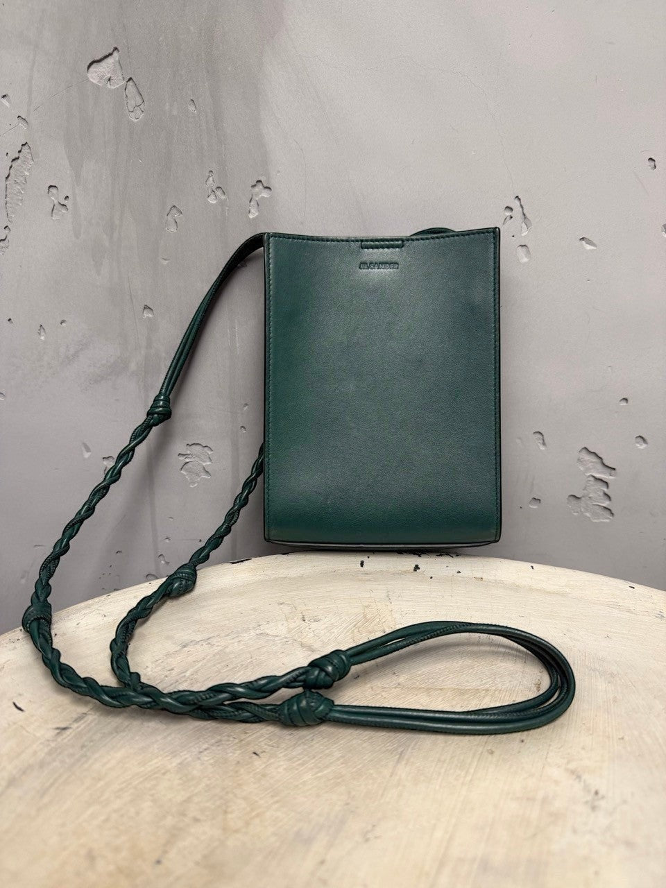 BERLIN VINTAGE CORNER forest green leather crossbody bag with braided strap and adjustable knots.
