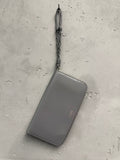 BERLIN VINTAGE CORNER grey polished leather zip-around wallet with braided wristlet strap and embossed logo.