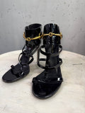BERLIN VINTAGE CORNER Gucci black patent leather strappy high heel sandals with gold-tone horsebit ankle cuff detail.