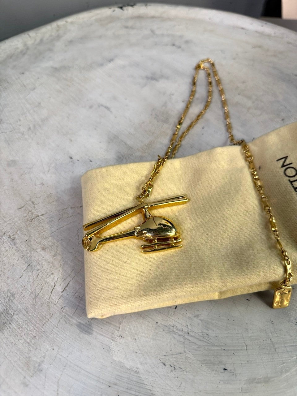 BERLIN VINTAGE CORNER gold-tone helicopter pendant necklace with delicate chain and embossed charm.