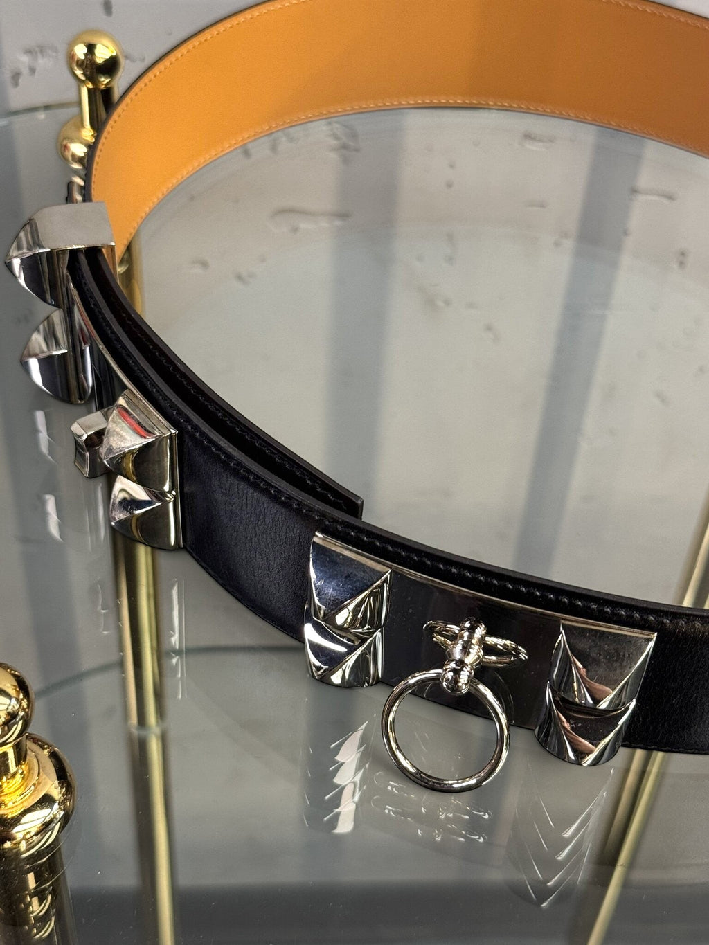 BERLIN VINTAGE CORNER Hermes black leather waist belt with silver pyramid studs and ring detail on a glass display