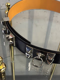 BERLIN VINTAGE CORNER Hermes black leather waist belt with silver pyramid studs and ring detail on a glass display