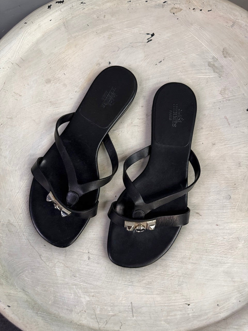 BERLIN VINTAGE CORNER black leather HERMÈS PARIS thong sandals with silver metallic hardware and flat soles