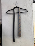 BERLIN VINTAGE CORNER men's tie with tan, black, grey, and blue houndstooth pattern and diagonal stripes.