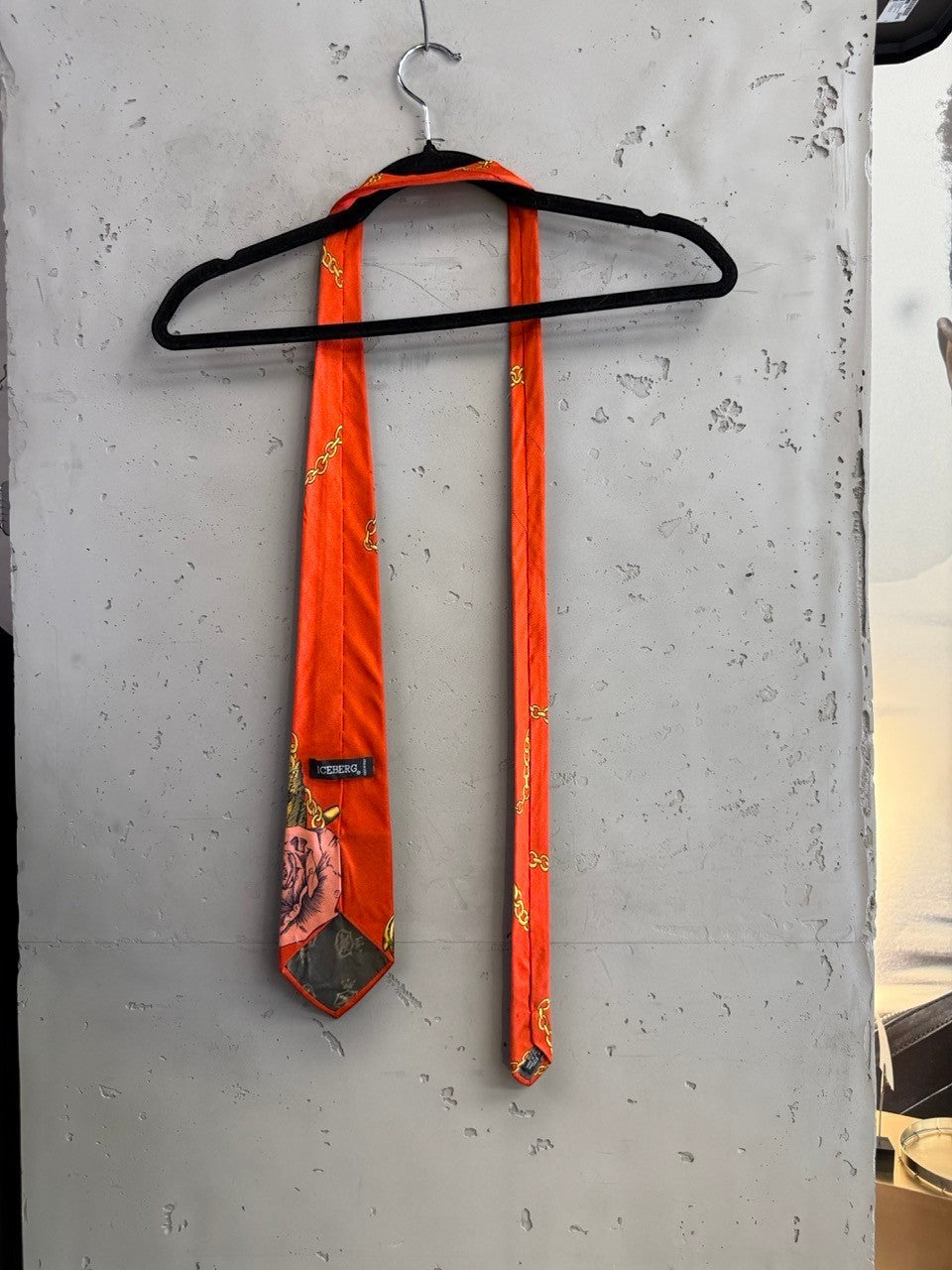BERLIN VINTAGE CORNER orange ICEBERG necktie with crocodile, gold chain, and floral print on a black hanger