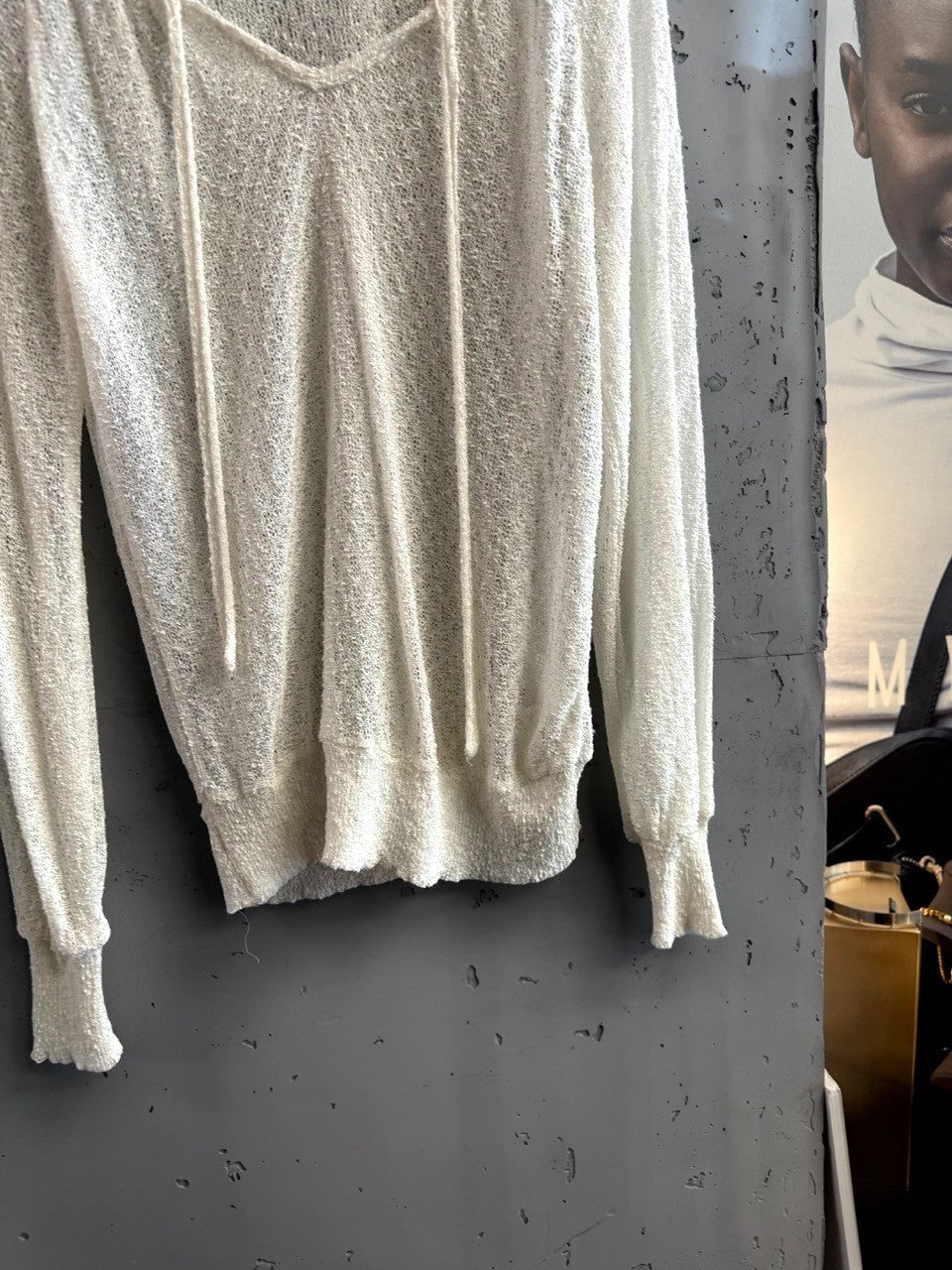 BERLIN VINTAGE CORNER ivory sheer knit V-neck pullover sweater with drawstring detail and ribbed cuffs.