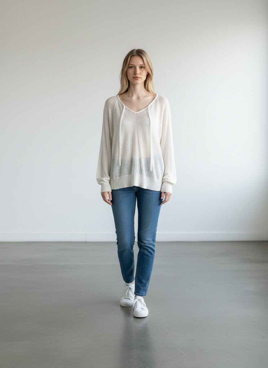 BERLIN VINTAGE CORNER ivory sheer knit V-neck pullover sweater with drawstring detail and ribbed cuffs.